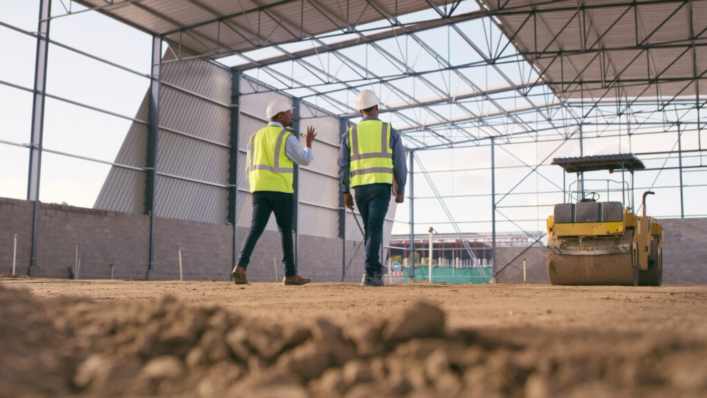 Construction Services 1 Engineering, cooperation and men on construction site planning and project management Contractor team in warehouse, bb in industrial service and work in building development